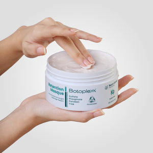 Beauty Garage Botoplexx Retention Masque in hand, highlighting deep conditioning, moisture retention, and hair nourishment.
