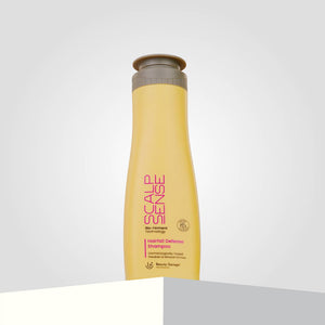 ScalpSense Hairfall Defense Shampoo bottle, with its striking purple text, stands confidently against a gray background.