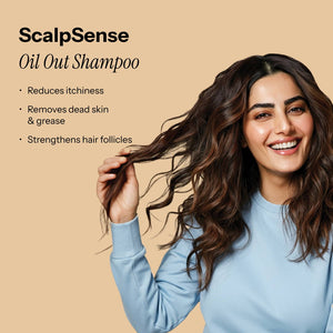 ScalpSense Oil Out Shampoo model, smiles as she gently touches her wavy hair. Benefits: reduces itchiness, removes dead skin 